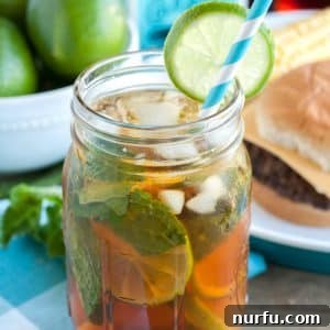 Mason jar with tea, mint and lime slice.