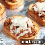 A slice of Texas Toast topped with saucy sloppy joe meat and perfectly melted cheese.