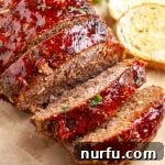 Slices of Lipton Onion Soup Meatloaf arranged on a cutting board with toasted bread.