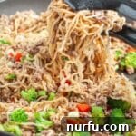Savory ramen noodles with ground beef and mixed vegetables in a skillet, ready to be served.