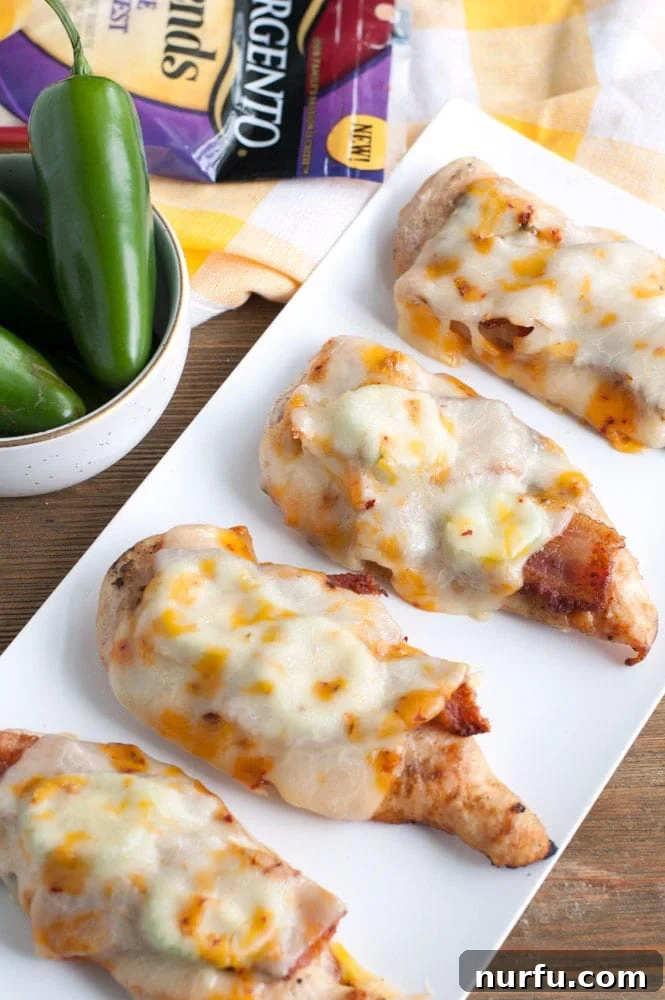 Savoring Freedom: 37 Delicious Memorial Day Recipes 27 Two perfectly grilled chicken breasts topped with crispy bacon and sliced jalapeños, ready to be served.