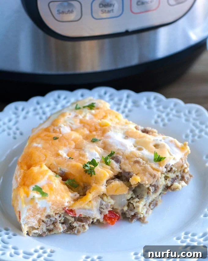 Hearty Breakfast Casserole on a plate A perfectly cooked Instant Pot Breakfast Casserole slice on a plate, showcasing the layers of sausage, eggs, cheese, peppers, and onions.