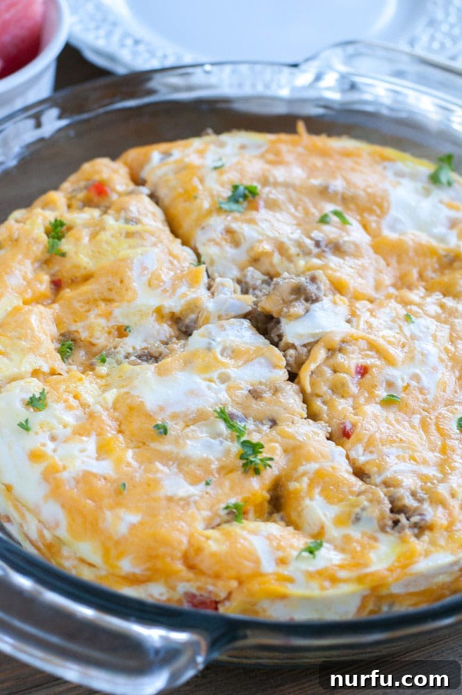 Breakfast casserole in a dish A close-up view of the Instant Pot Sausage Breakfast Casserole in a round baking dish, fresh out of the Instant Pot, showing melted cheese and perfectly cooked eggs.