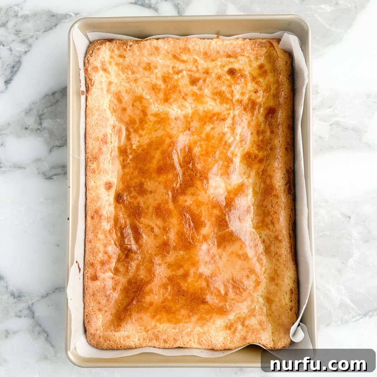 A baking pan filled with perfectly baked chess squares, showing their inviting golden top.