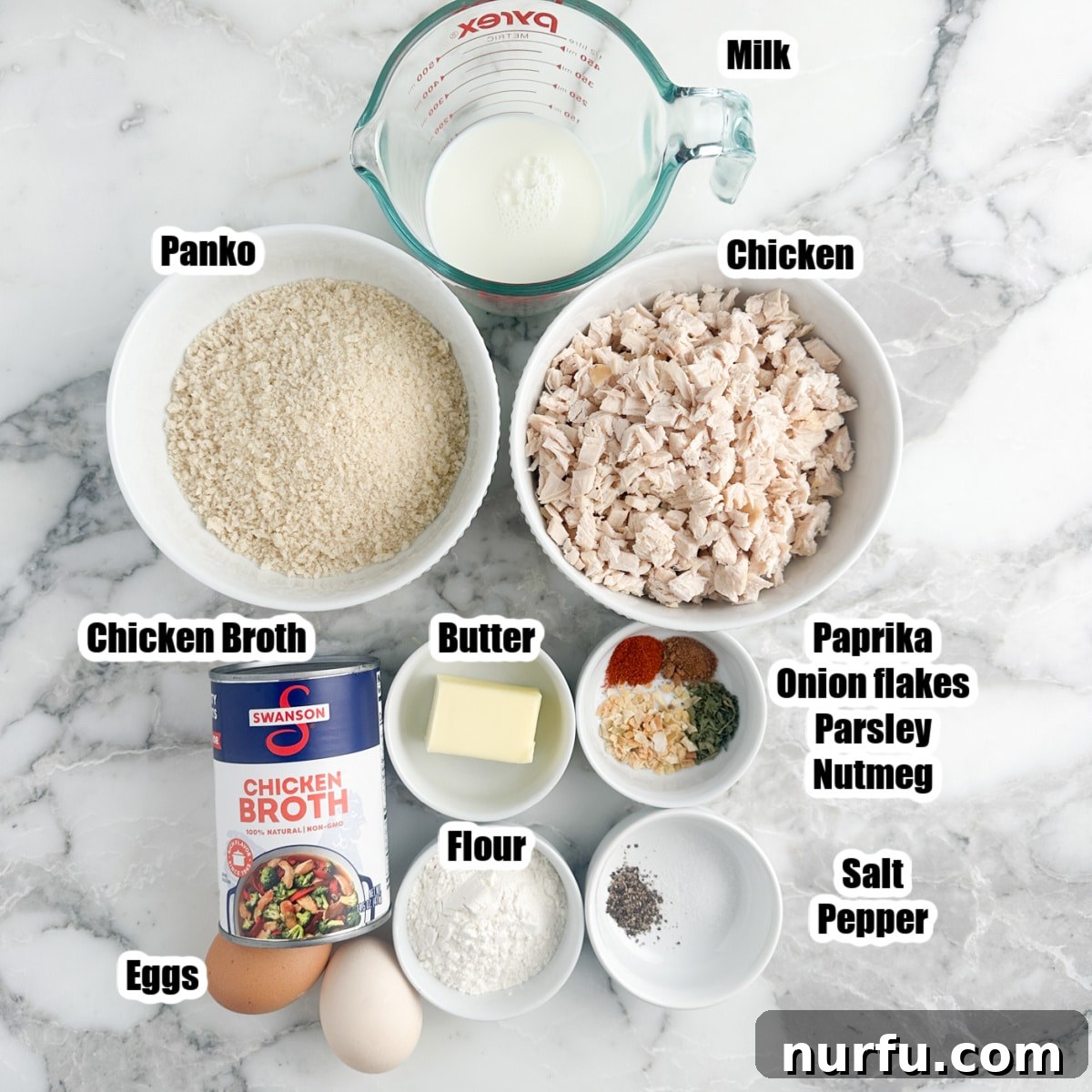 Crispy Golden Chicken Croquettes 3 Bowls of raw ingredients for chicken croquettes, including diced chicken, panko breadcrumbs, milk, butter, various seasonings, and chicken broth, arranged on a rustic wooden surface.