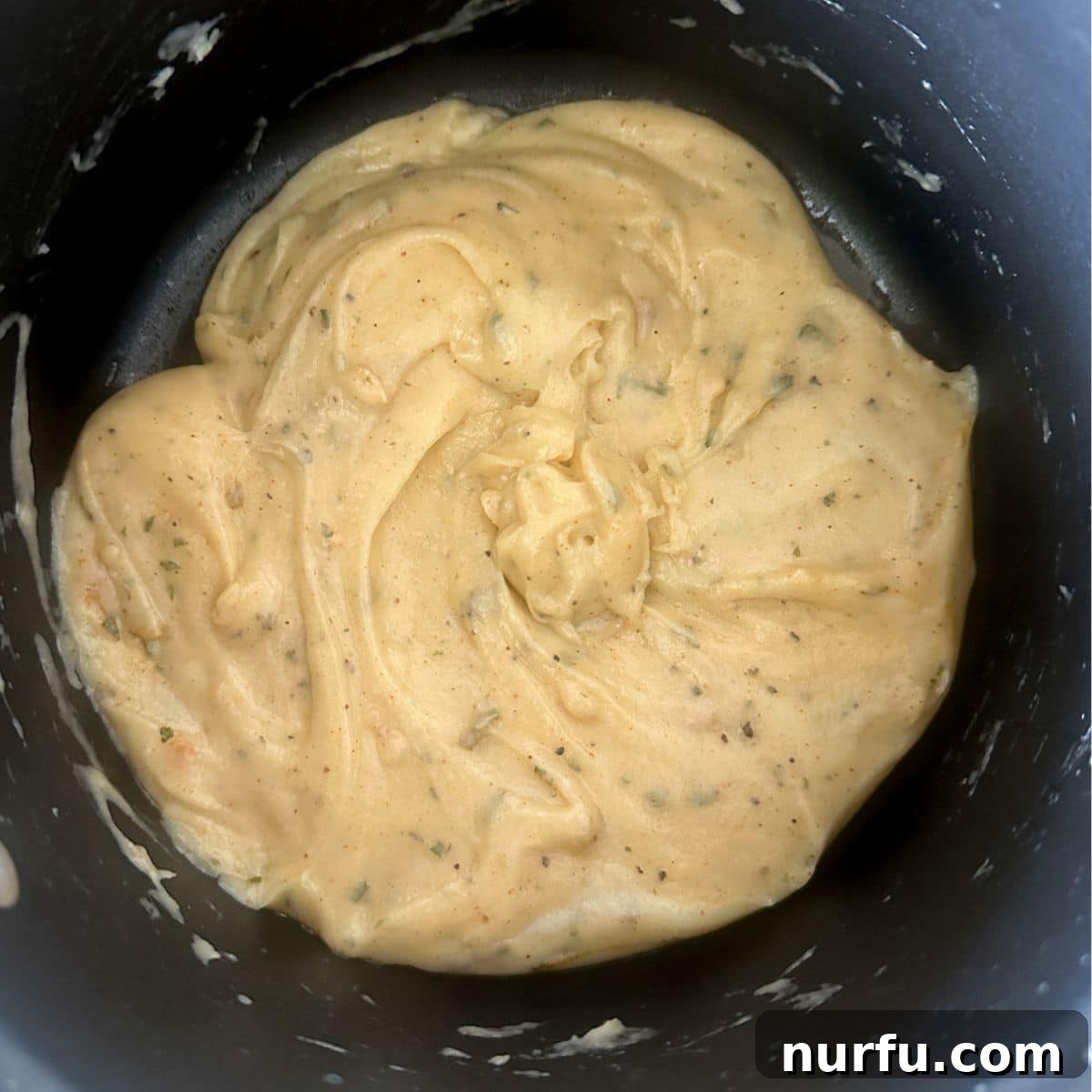 Crispy Golden Chicken Croquettes 5 Thickened flour and milk mixture (roux) in a saucepan, forming the creamy base for chicken croquettes.