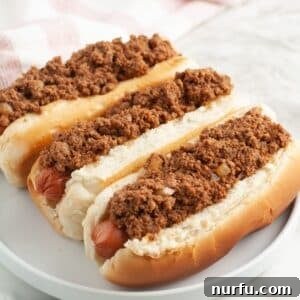 Plate of three chili dogs.