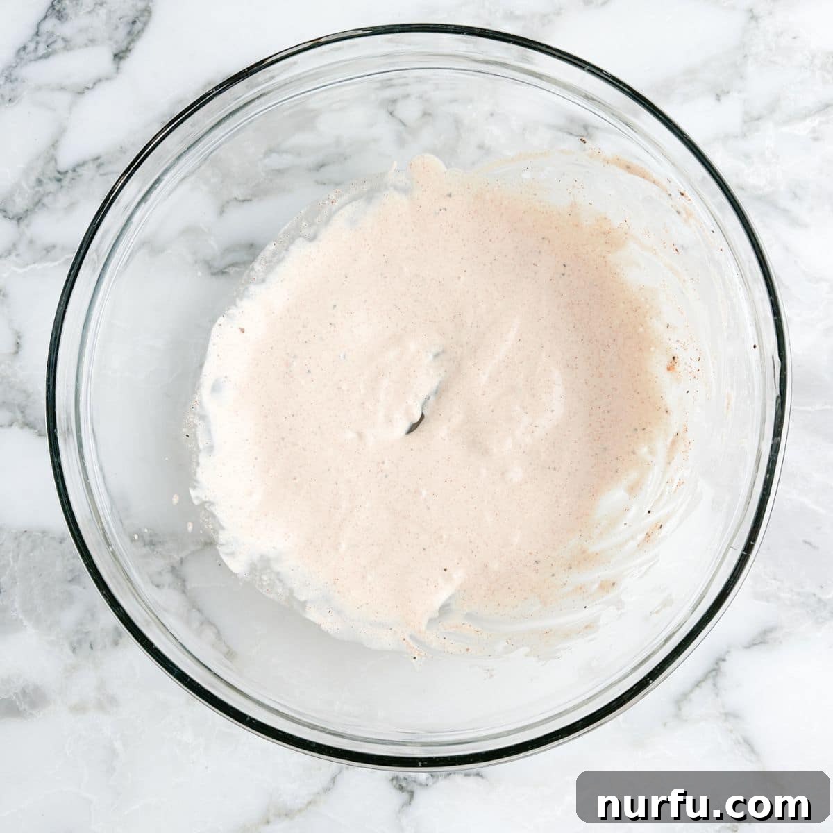 Tenderizing Mayonnaise Chicken Marinade 4 A mixing bowl holds the creamy, seasoned mayonnaise chicken marinade, perfectly blended and ready to infuse flavor into the chicken.