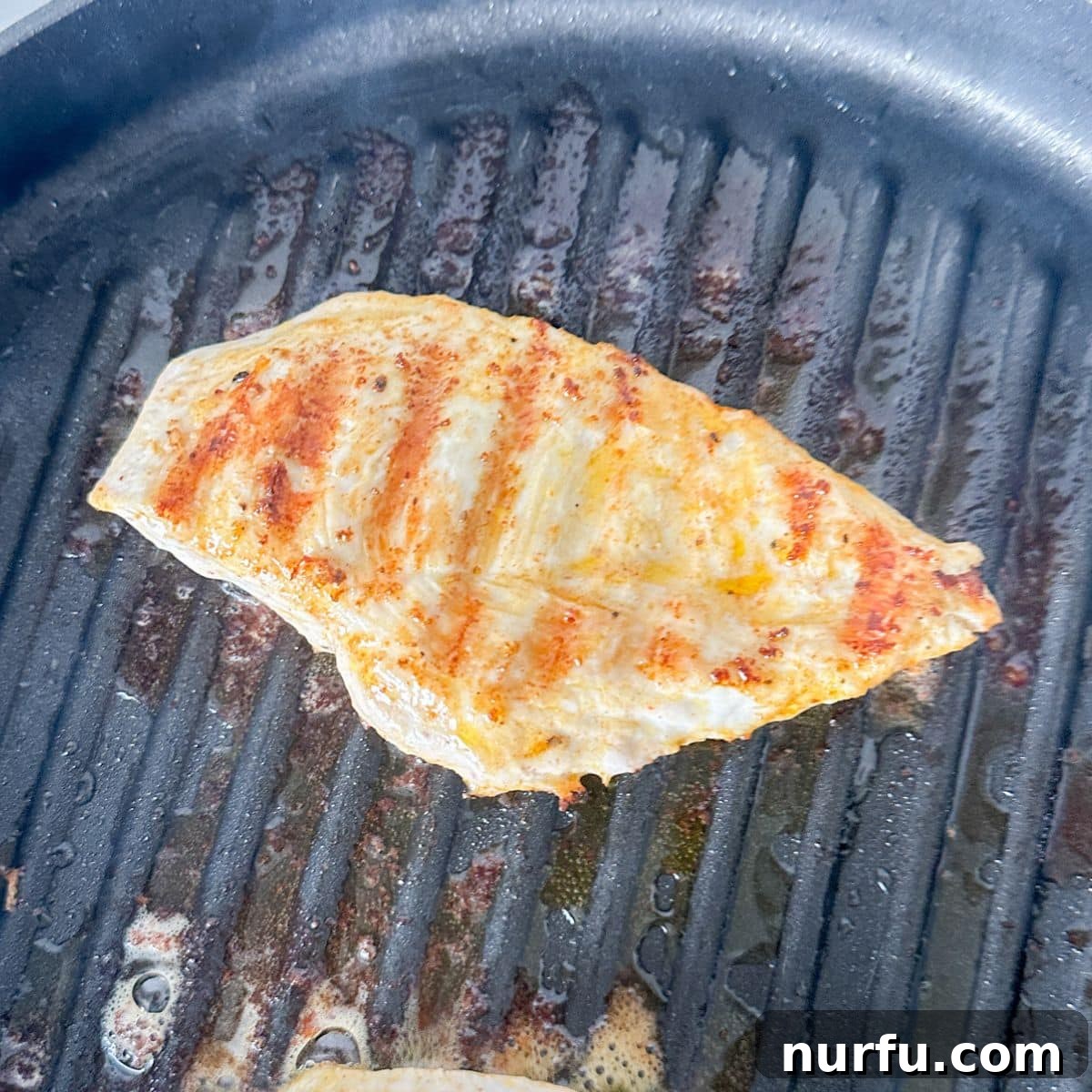 Tenderizing Mayonnaise Chicken Marinade 7 A grill pan sizzles with perfectly seared chicken breasts, showcasing the golden-brown crust achieved after marinating in the delicious mayo blend.