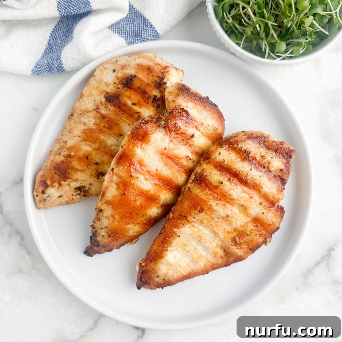 Tenderizing Mayonnaise Chicken Marinade 8 A beautifully plated grilled chicken breast, glistening and golden, ready to be enjoyed, showcasing the success of the mayonnaise marinade.