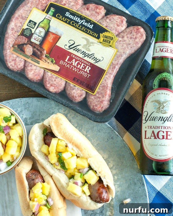 picture of bratwurst and beer Close-up of juicy bratwursts ready for grilling, alongside a cool Yuengling Lager beer.