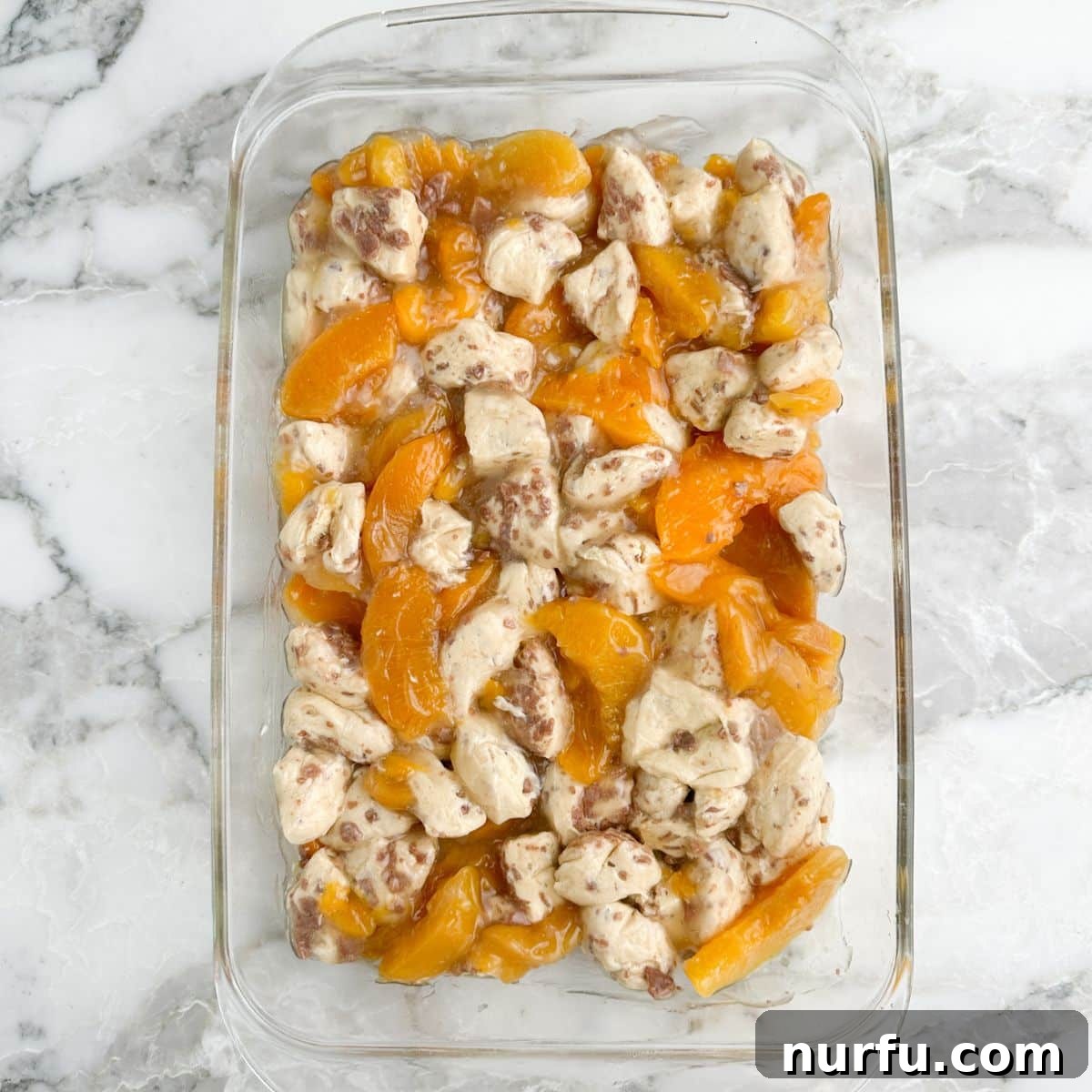Peachy Cinnamon Swirl Cobbler 7 The cinnamon roll and peach mixture spread evenly in a prepared 9x13 casserole dish.