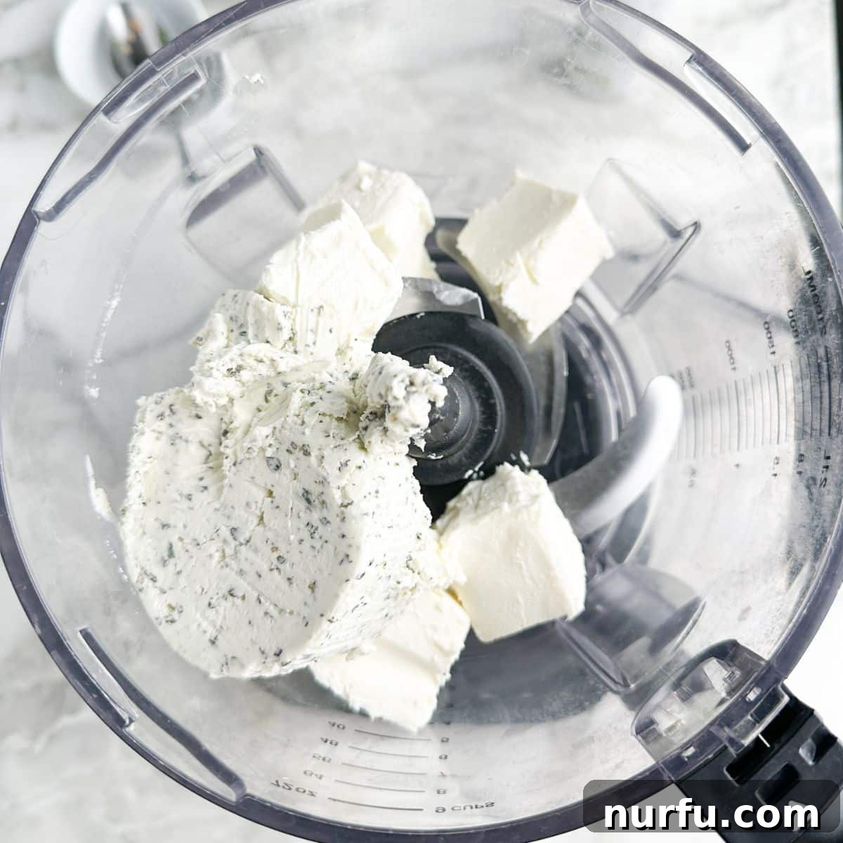 Sun-Kissed Bruschetta Topping 4 A food processor bowl containing softened cream cheese and Boursin cheese, ready for blending to create the creamy dip base.