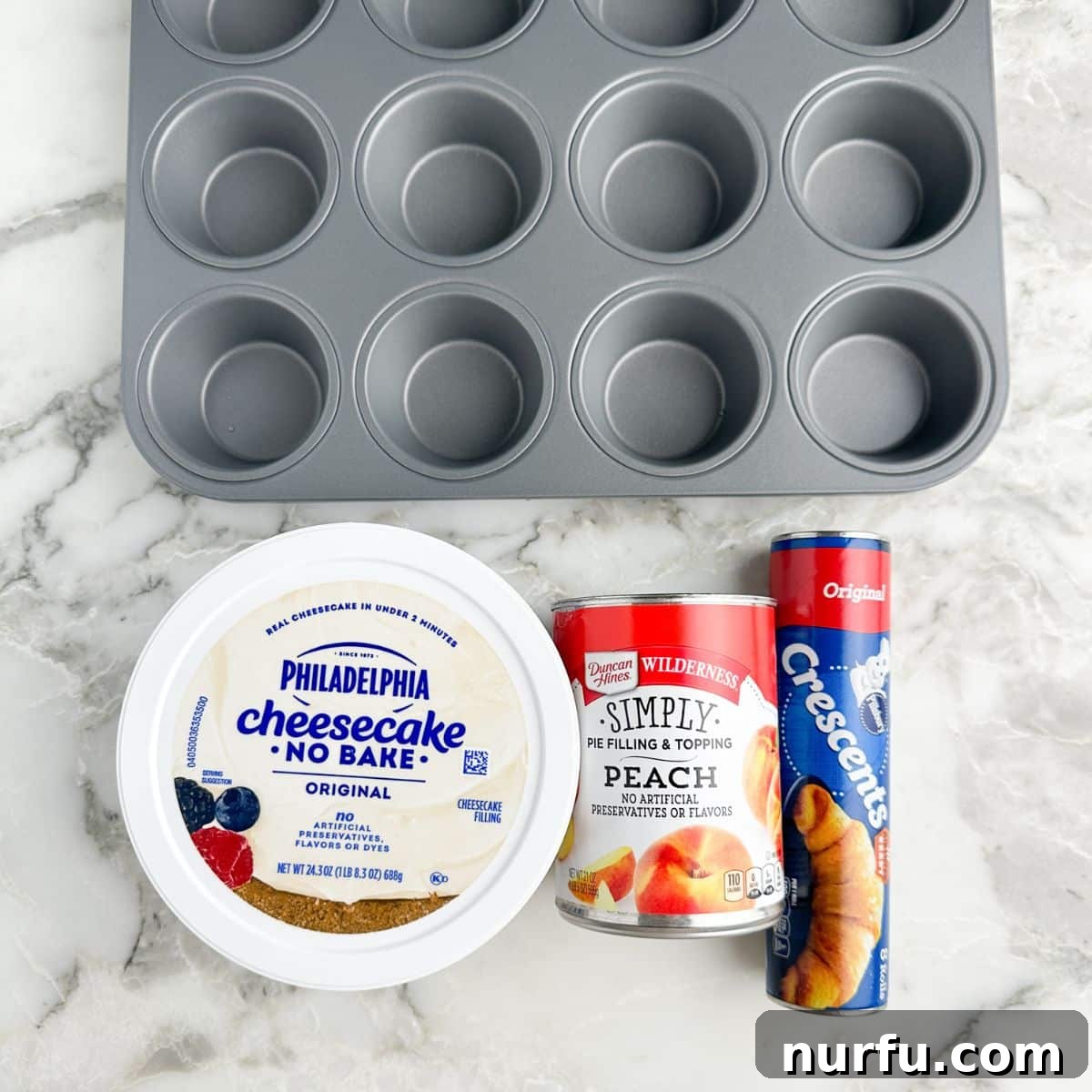 Flaky Peach Cheesecake Delights 3 Tub of Philadelphia cheesecake mixture, can of peach pie filling, can of crescent rolls laid out.