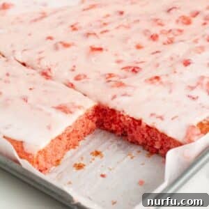 A slice of Strawberry Pink Lady Cake on a plate.