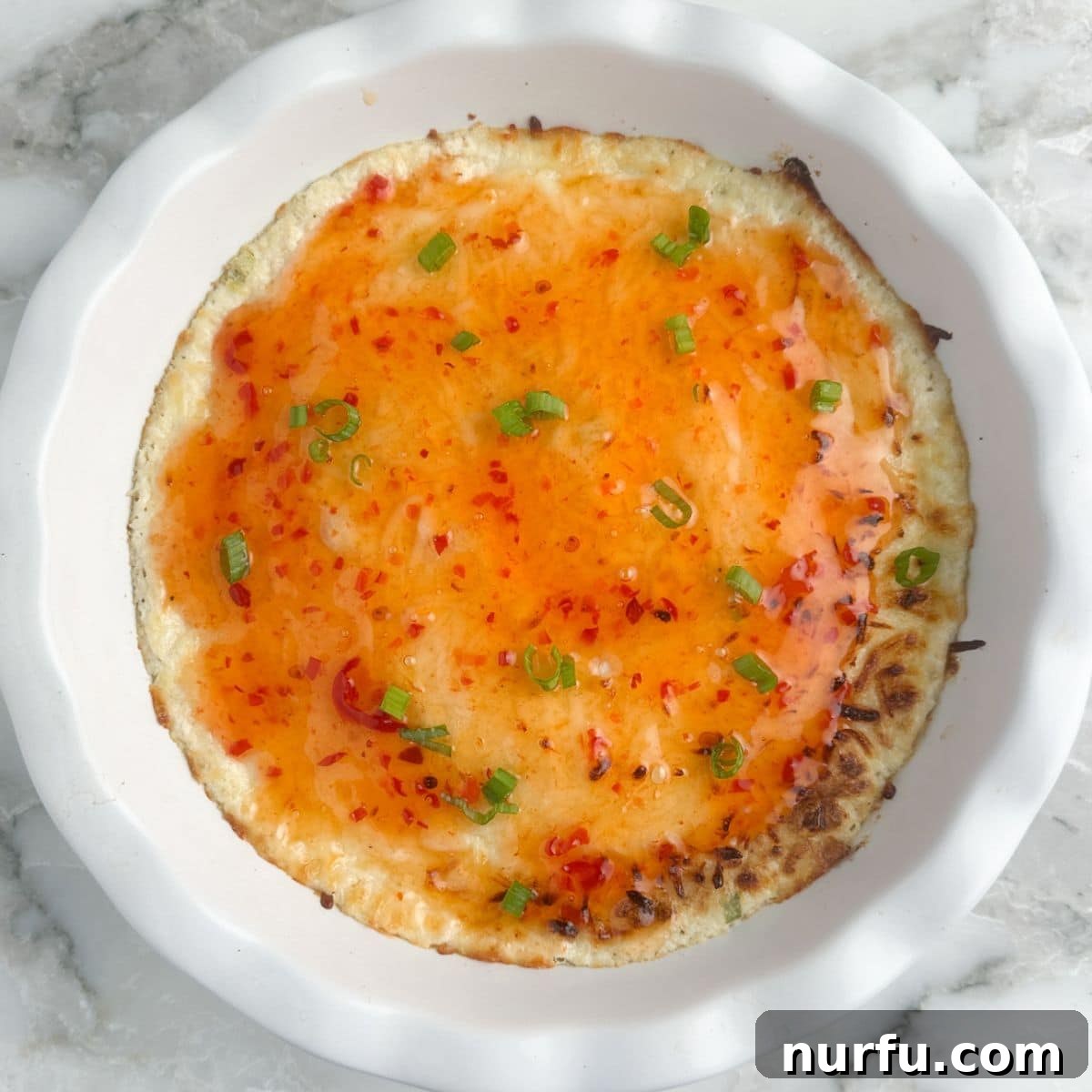 Irresistible Crab Rangoon Dip 6 Baking dish with crab rangoon dip topped with sweet chili sauce.