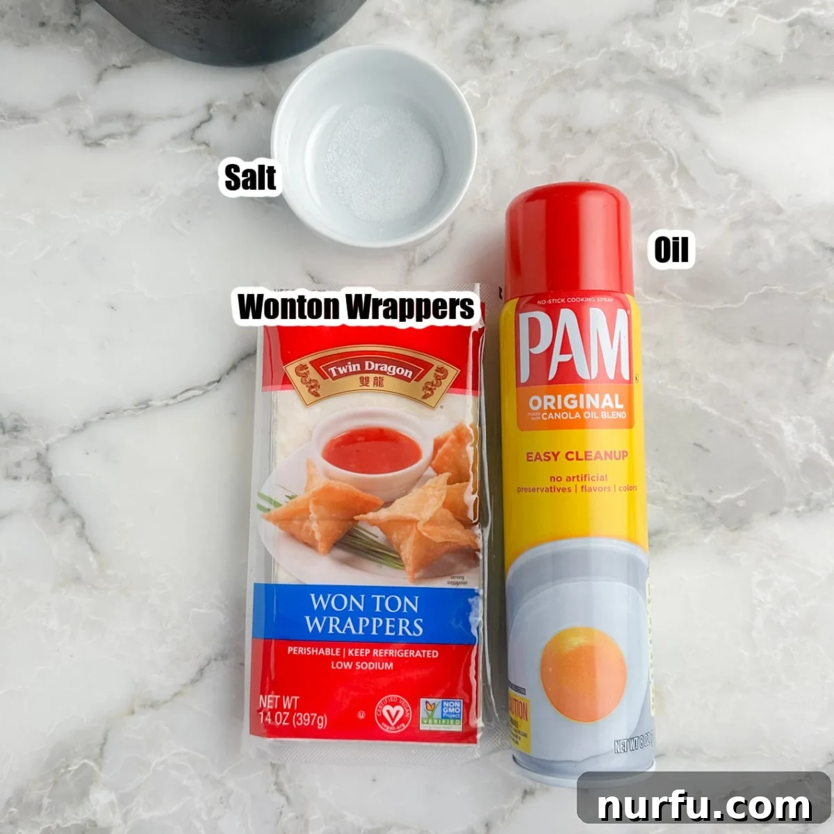 Effortless Air Fryer Wonton Crisps 3 A visual display of the main ingredients: a package of wonton wrappers, a small bowl of sea salt, and a can of cooking spray.