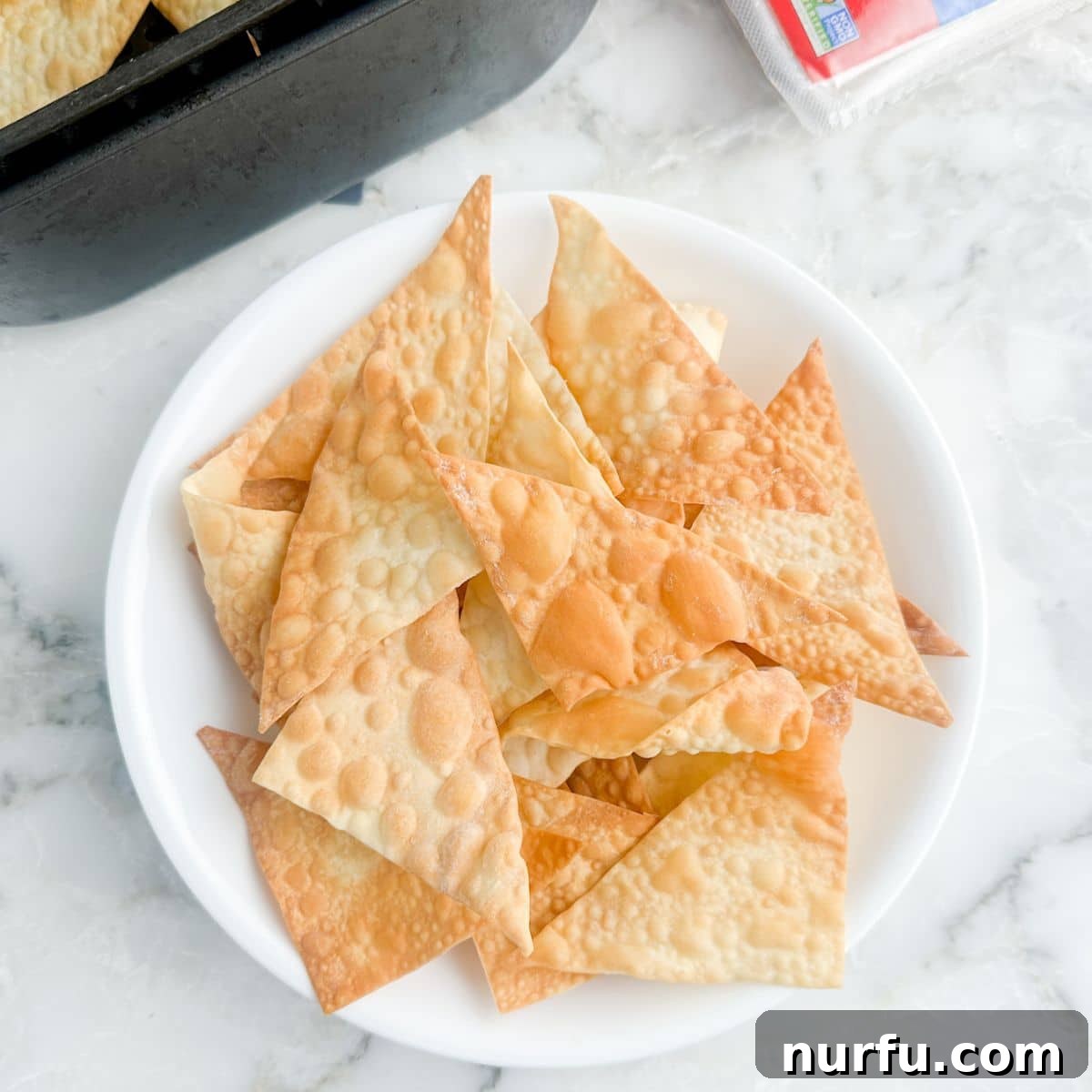 Effortless Air Fryer Wonton Crisps 6 A second view of a bowl of golden, crispy wonton chips, highlighting their appealing texture.