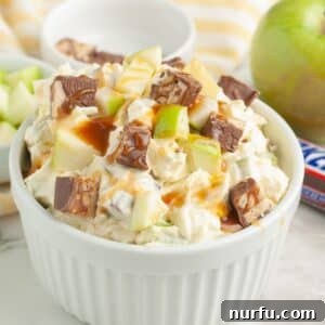 Snickers Caramel Apple Dream 8 Bowl of Snickers Caramel Apple Salad, garnished with extra Snickers and caramel drizzle.