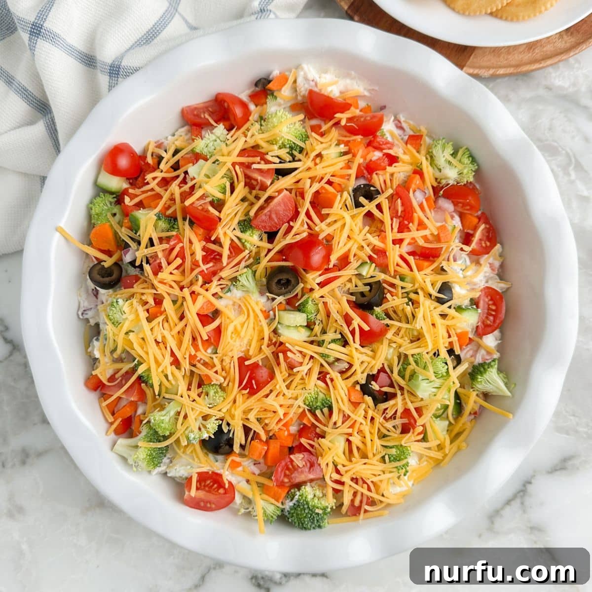 Garden Fresh Pizza Dip 7 Pie dish with veggie dip.