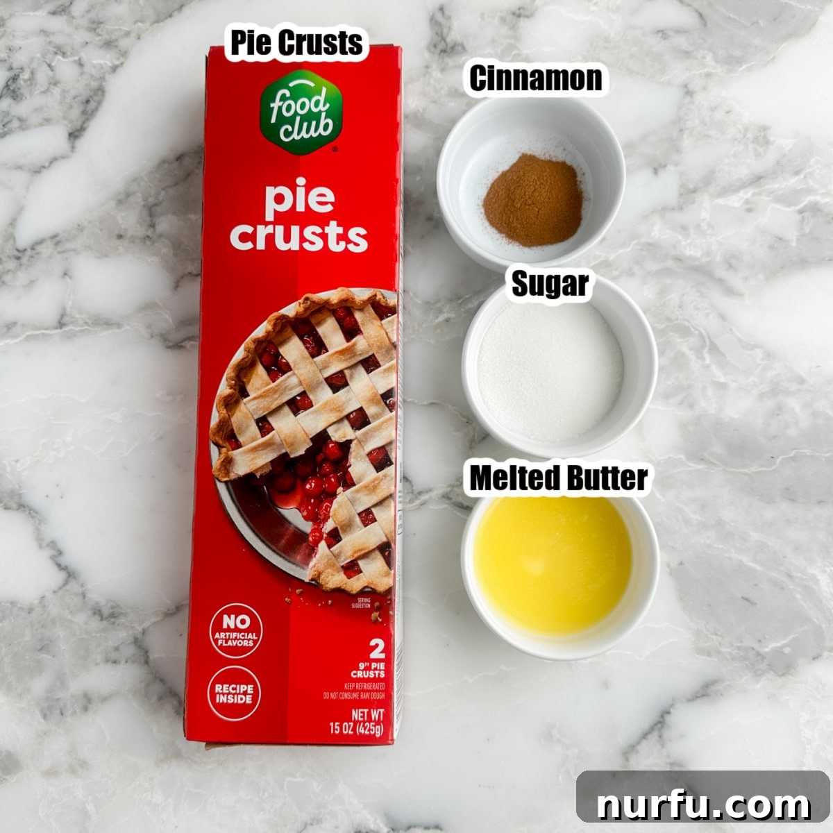 A visual display of the four essential ingredients: unrolled pie crust, bowls of ground cinnamon, granulated sugar, and melted butter.