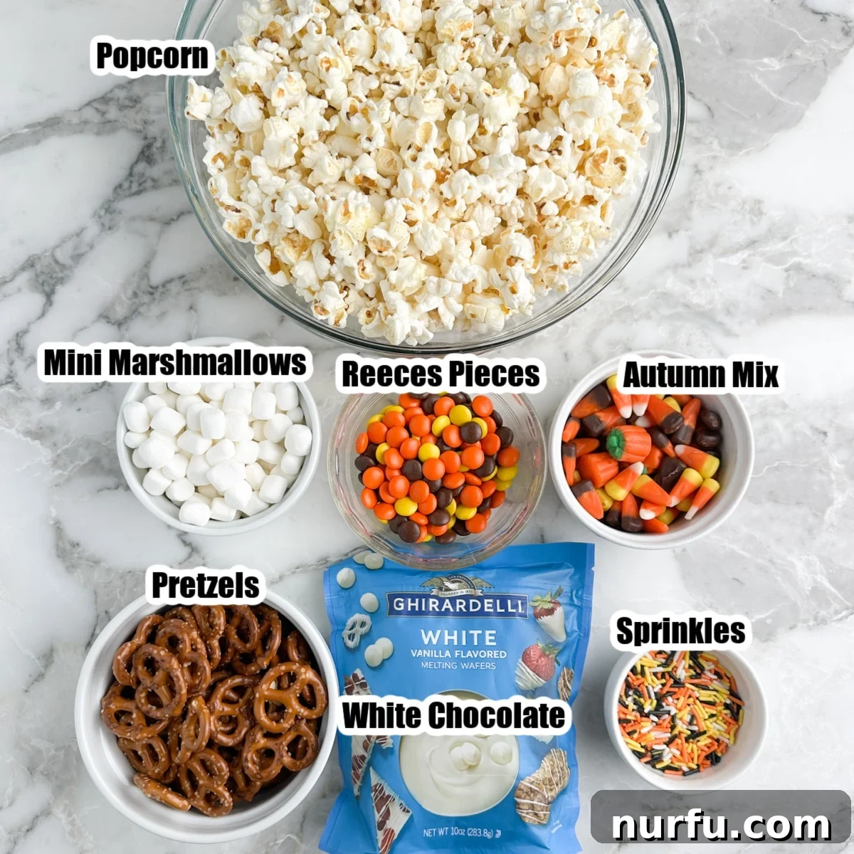 Sweater Weather Popcorn Mix 3 Bowl of popcorn, pretzels, mini marshmallows, candy, white chocolate melts, and sprinkles laid out.