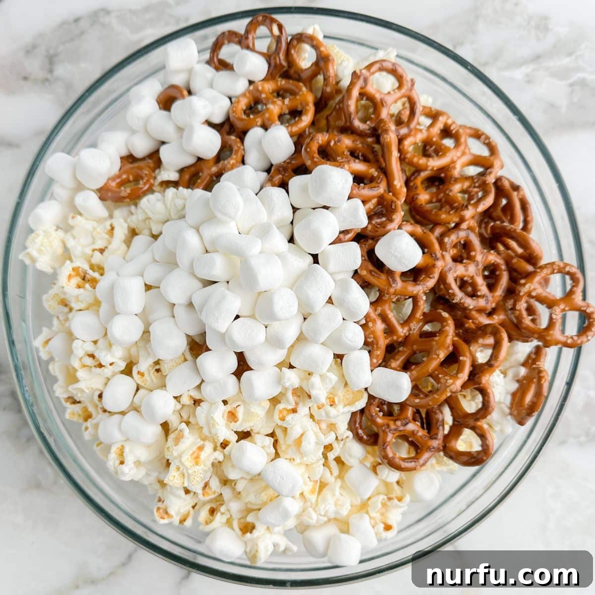 Sweater Weather Popcorn Mix 5 Bowl of popcorn, marshmallows, and pretzels.