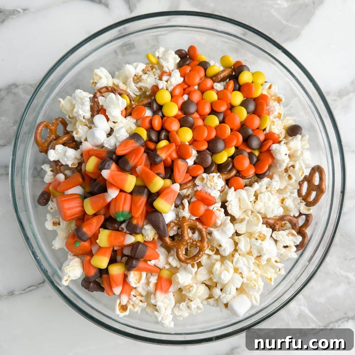 Sweater Weather Popcorn Mix 6 Bowl of popcorn, pretzels, and candy.