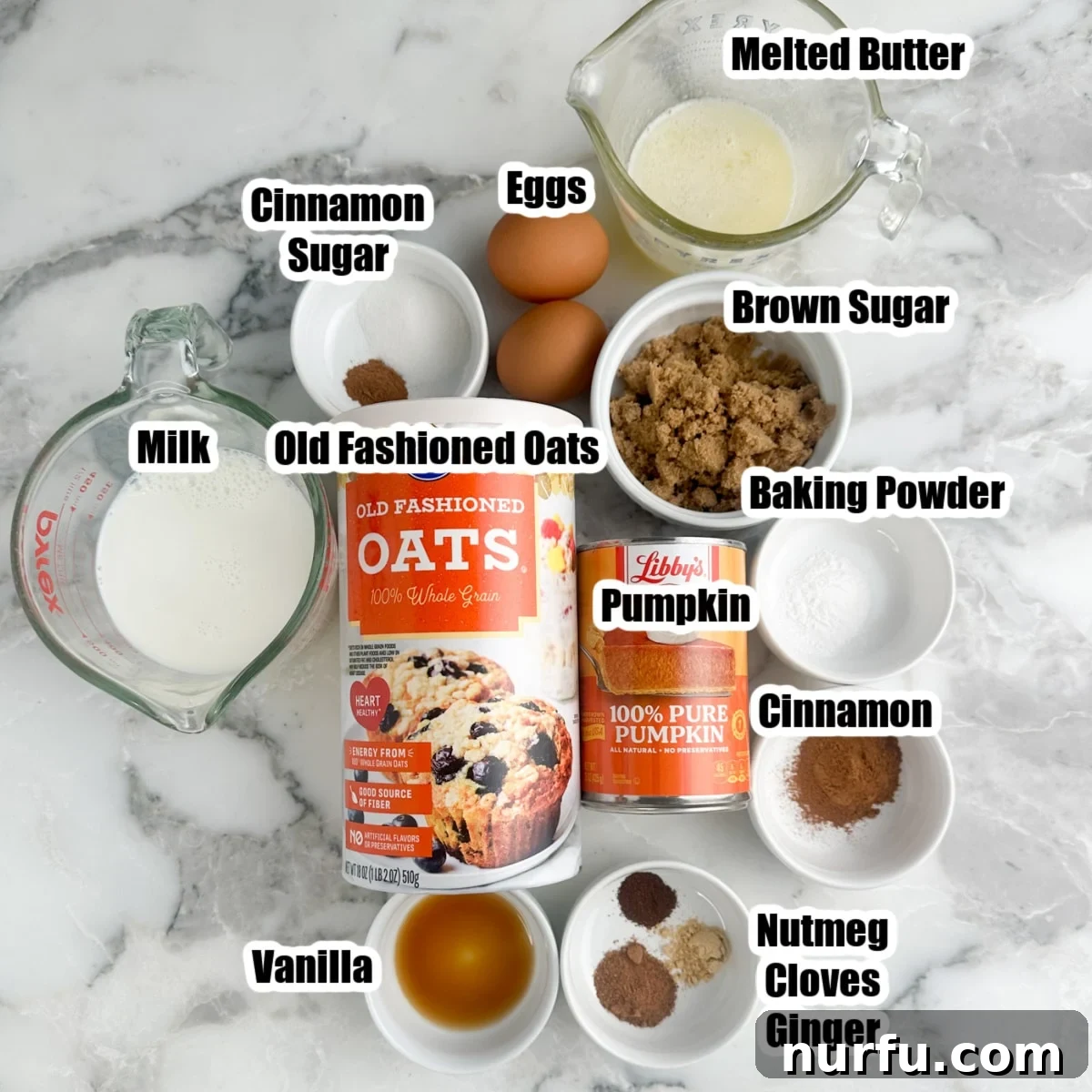 Warm Pumpkin Spice Baked Oatmeal 3 Collection of fresh ingredients including oats, pumpkin puree, spices, and eggs, laid out for pumpkin baked oatmeal.
