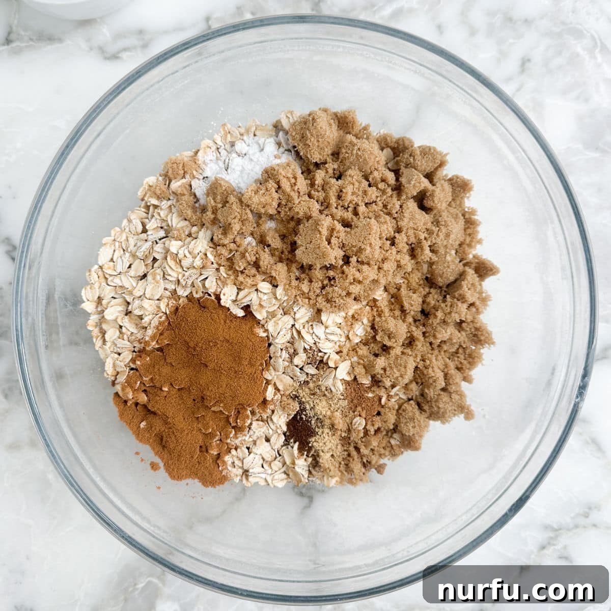 Warm Pumpkin Spice Baked Oatmeal 4 Bowl of oatmeal, brown sugar, spices, and baking powder mixed together.