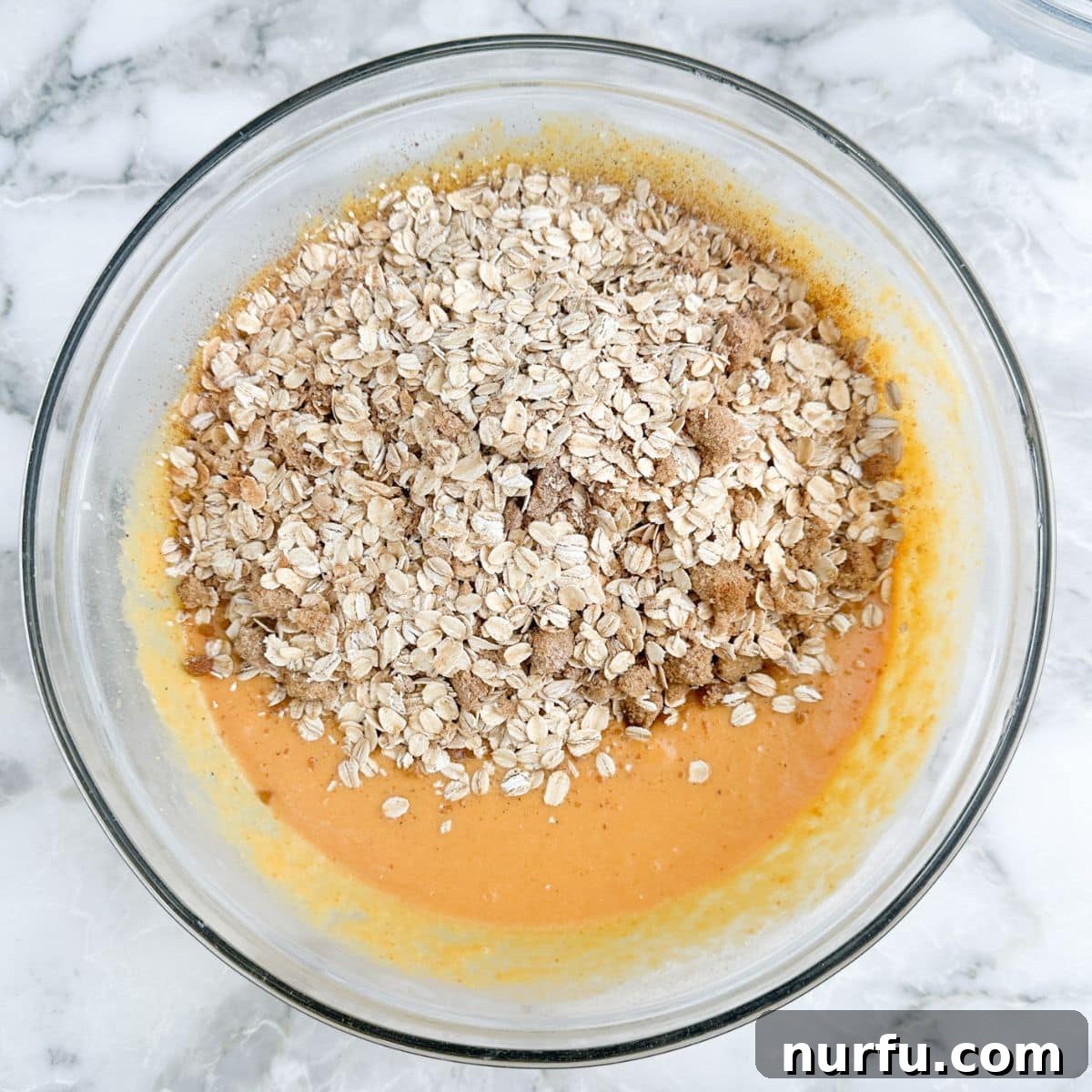 Warm Pumpkin Spice Baked Oatmeal 5 Bowl with pumpkin, milk, eggs, melted butter, vanilla, and spices, ready to be combined with dry ingredients.