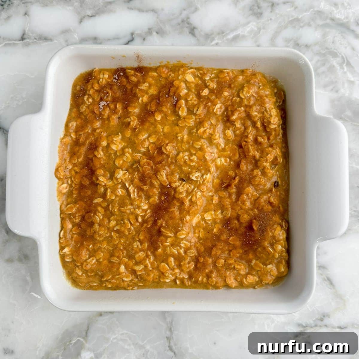Warm Pumpkin Spice Baked Oatmeal 6 Baking dish with golden-brown pumpkin oatmeal, fresh out of the oven.