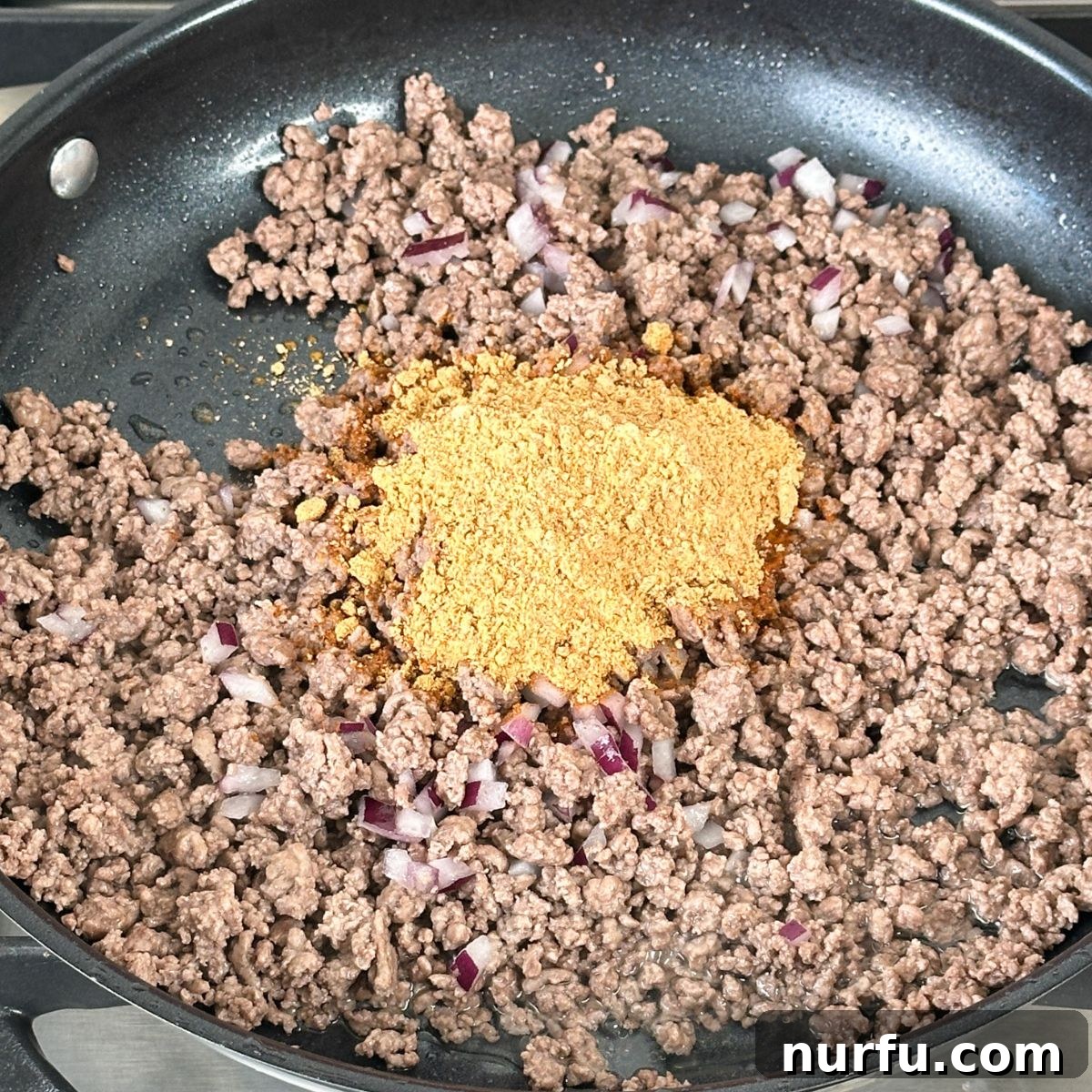 Catalina Kicked Taco Salad 4 Ground beef and taco seasoning mixing in a skillet.