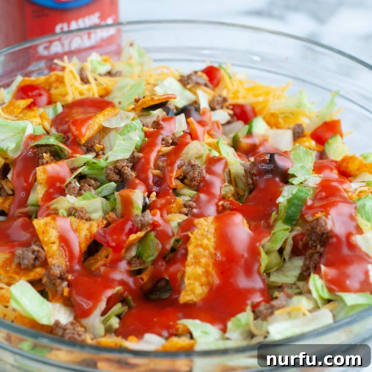 Catalina Kicked Taco Salad 8 Bowl of freshly tossed taco salad with Catalina dressing glistening.