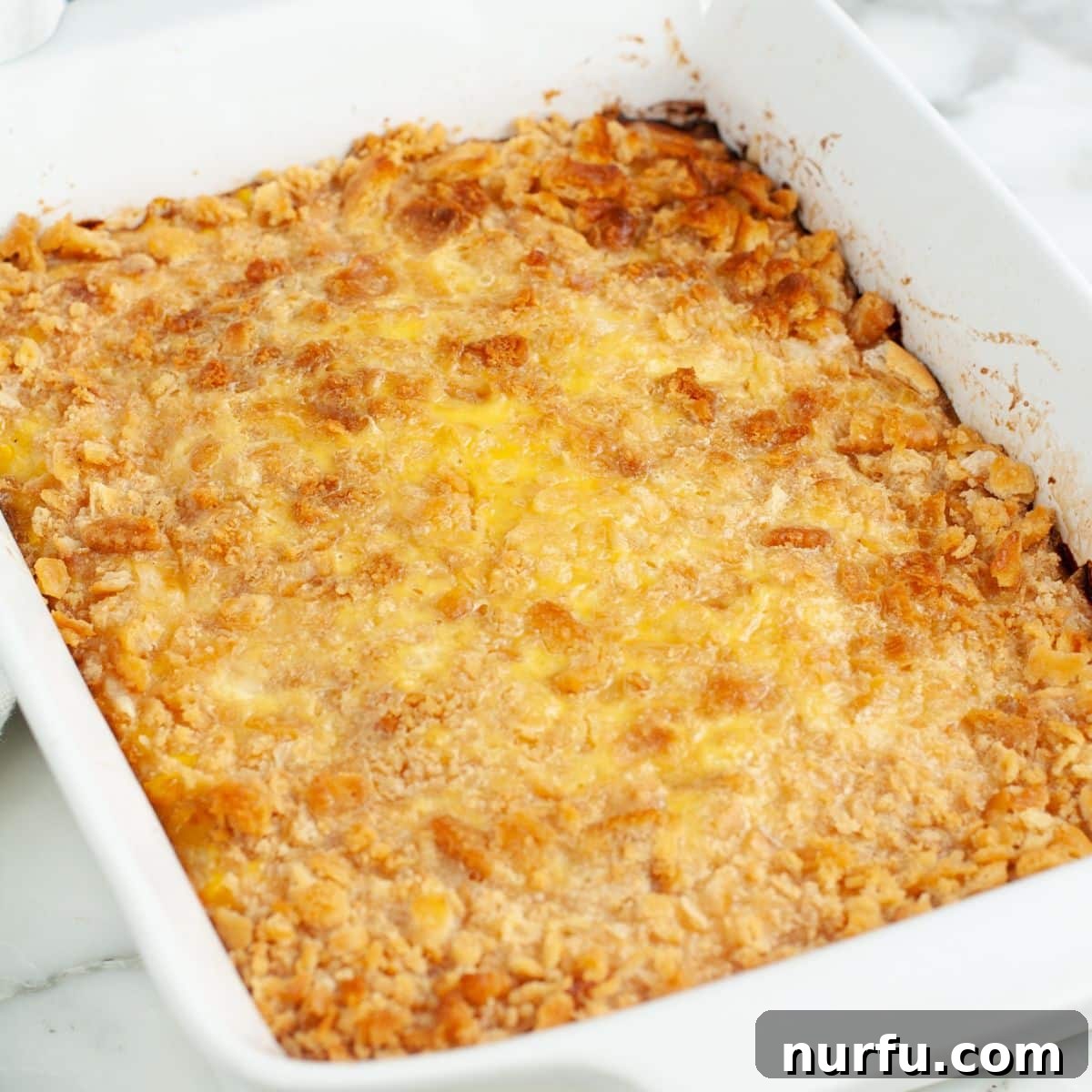Creamy Swiss Corn Gratin 8 A golden-brown Swiss Corn Bake casserole, fresh from the oven, resting in its baking dish, ready to be served.