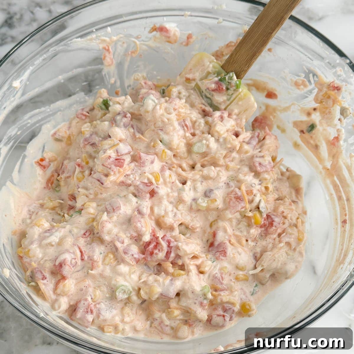 A serving bowl filled with finished Doritos dip, ready to be enjoyed.
