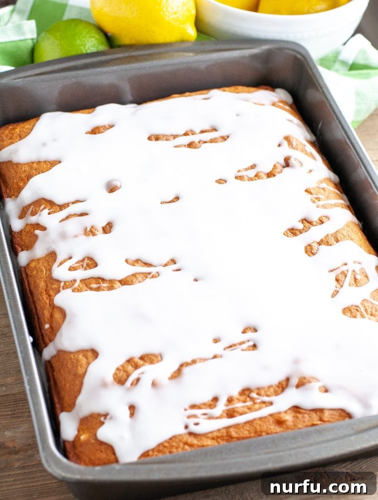 7 Up Cake in Pan Freshly baked 7 Up cake with a sweet glaze, cooling in a rectangular baking pan.