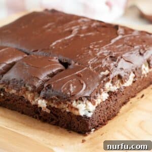 Coconut brownies on a cutting board.