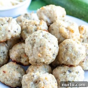 Plate of chicken meatballs with zucchini in background.