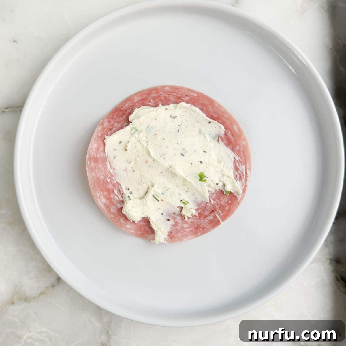 Savory Salami Bites 6 A single slice of salami spread with a thin layer of cream cheese mixture.