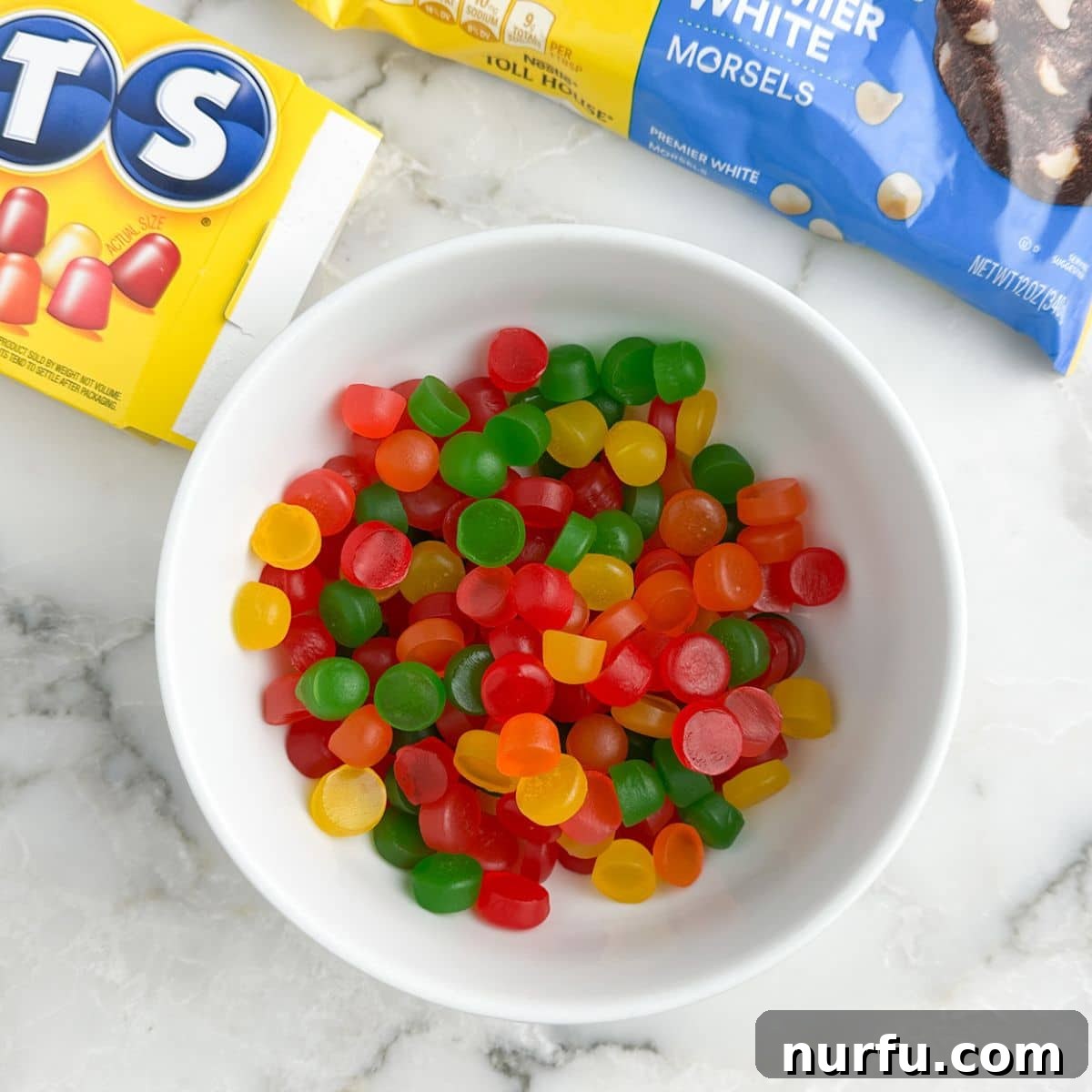 Gumdrop Nougat Cloud 4 A bowl filled with colorful Dots gumdrop candies, neatly cut in half, ready to be incorporated into the nougat.