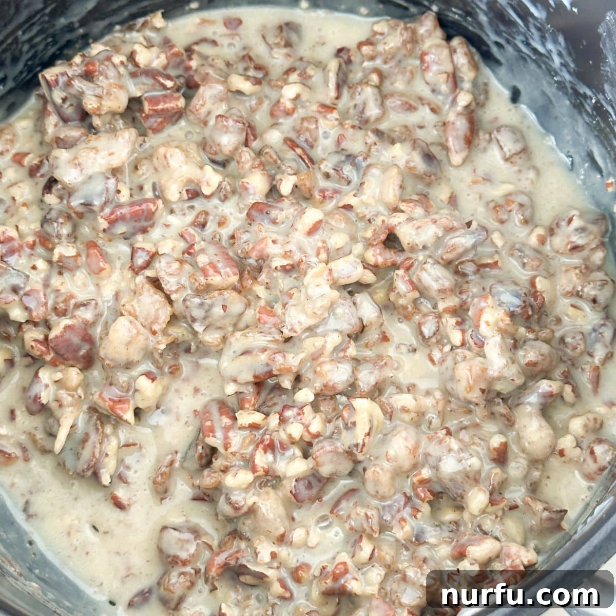 Sweet and Salty Ritz Cracker Delights 4 Saucepan with finely chopped pecans and sweetened condensed milk beginning to heat and combine.