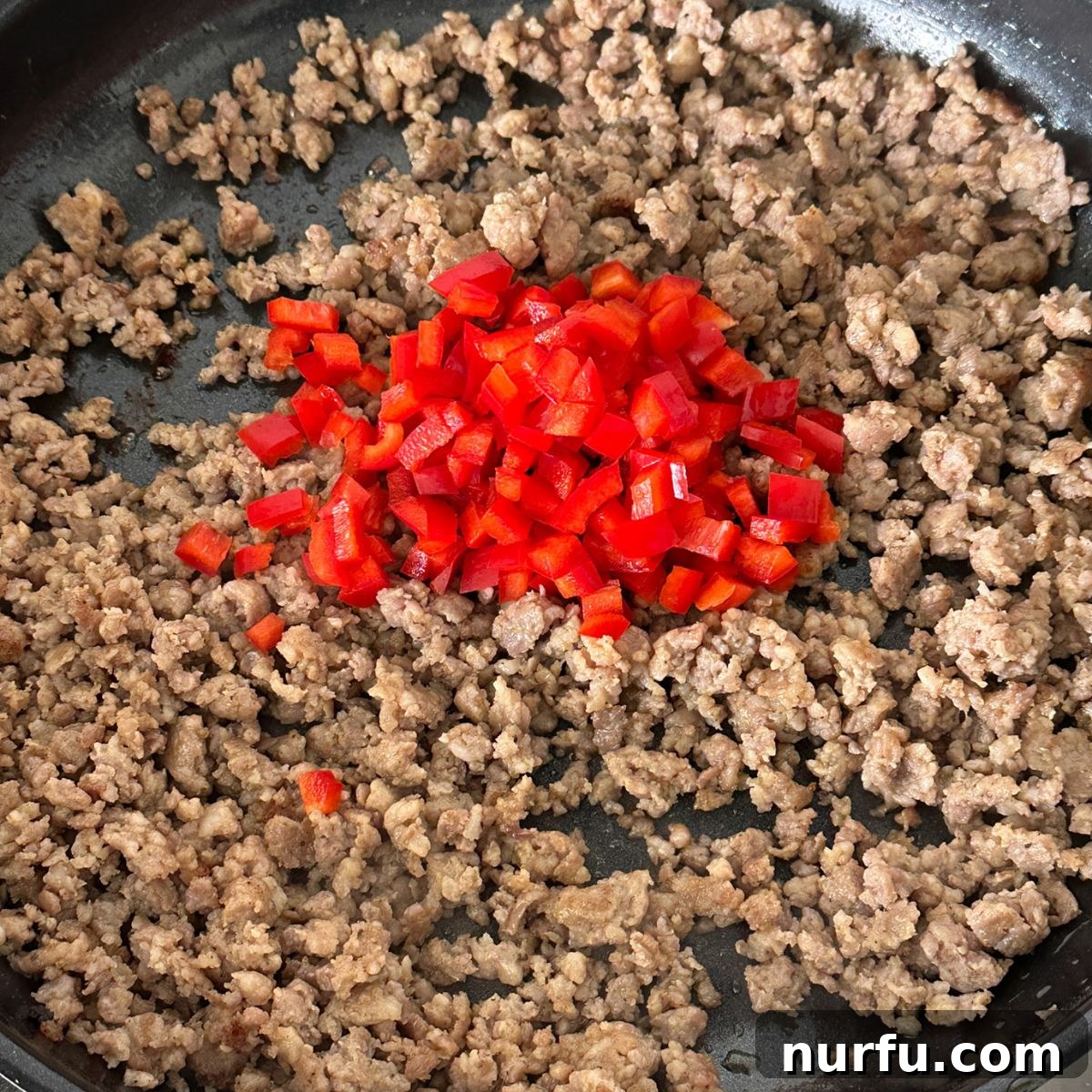 Sausage Cream Cheese Poppers 4 Skillet with cooked ground sausage and red pepper.