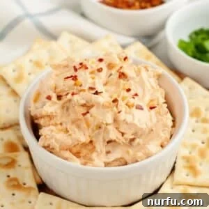 Bowl of fire cracker dip topped with red pepper flakes.