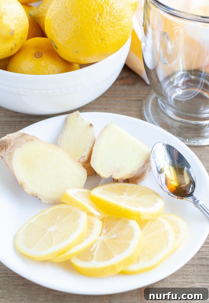 A bowl of fresh lemons and a plate of sliced ginger root, ready for brewing.