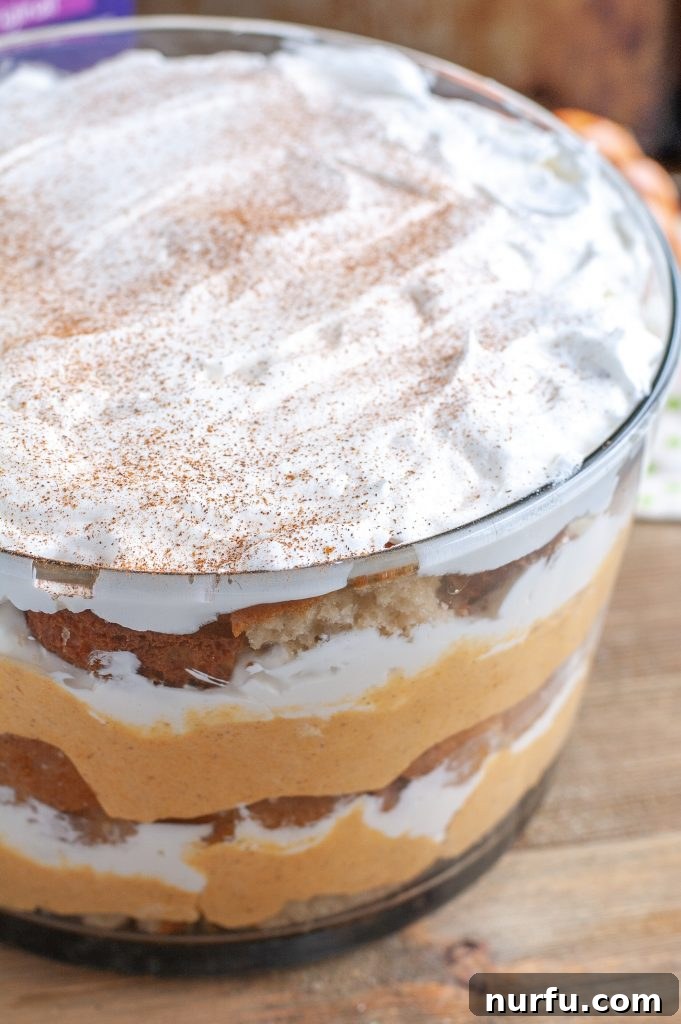 Pumpkin Chai Trifle Pumpkin Chai Trifle in a decorative glass bowl, showcasing its distinct layers of cake, pumpkin, and cream.
