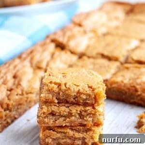 Stacked blondies on a table, showcasing the rich, golden hue of butterscotch brownies.