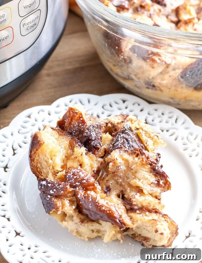 Delicious Instant Pot French Toast Casserole ready to serve Instant Pot French Toast Casserole on a plate, garnished with powdered sugar and berries