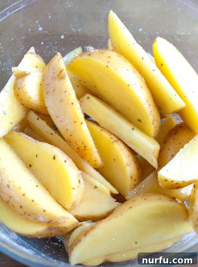 Ranch potato wedges Potatoes in a bowl with ranch seasoning