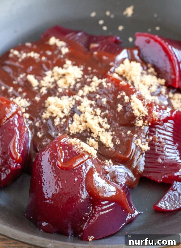 Homemade cranberry BBQ sauce simmering in a skillet Cranberry BBQ Sauce